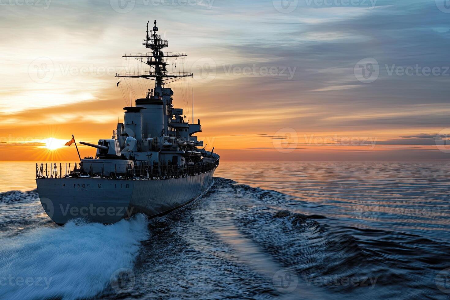 Naval ship sailing at sunset on calm waters. photo