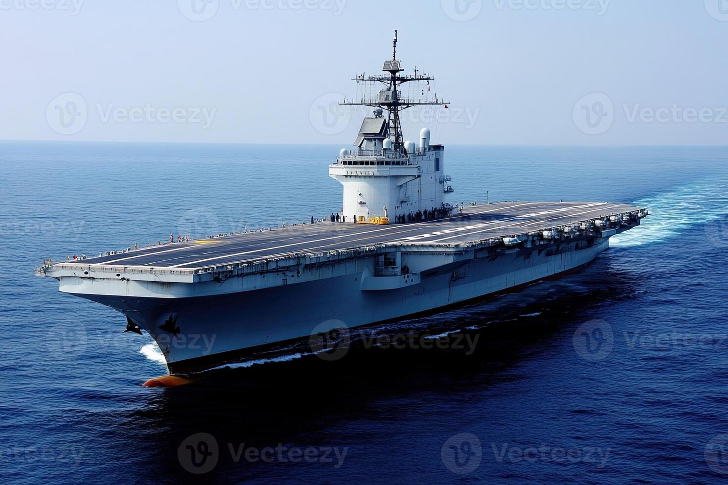 Aircraft carrier navigating through open waters. photo