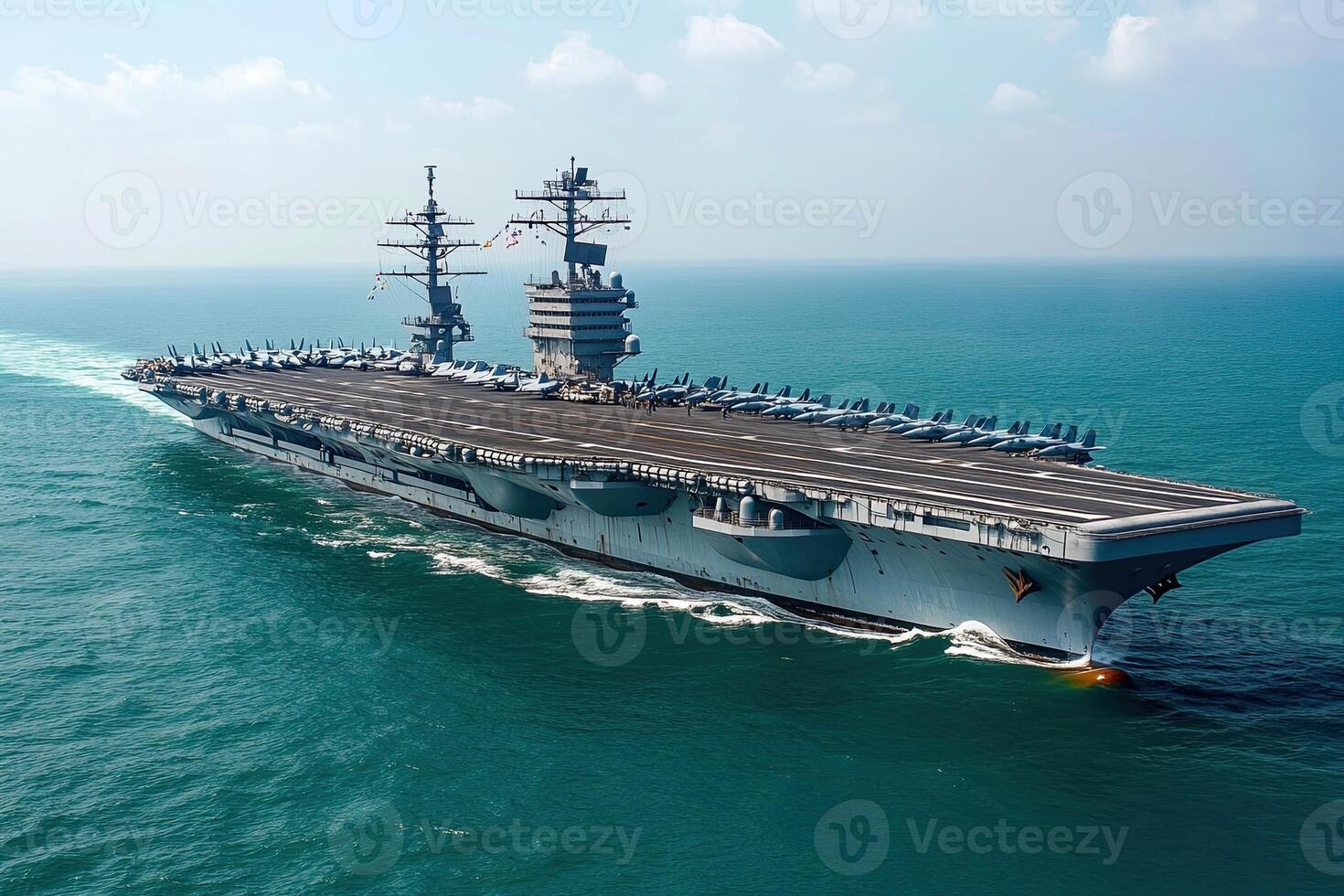 Aircraft carrier navigating through the ocean waters. photo