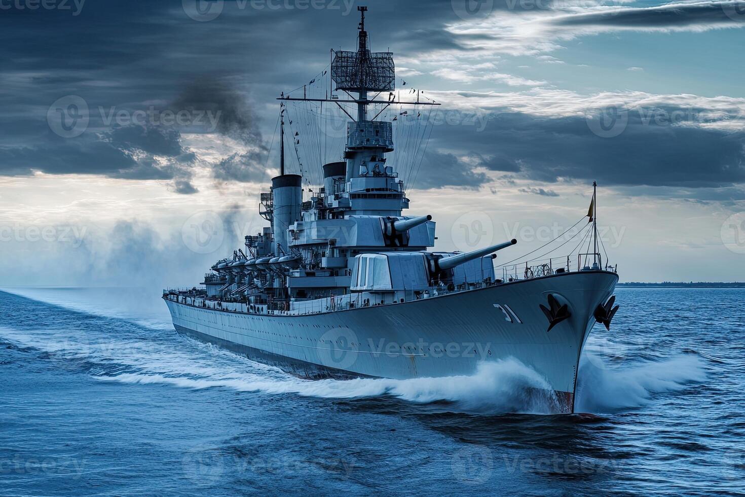 Battleship navigating through water under a cloudy sky. photo