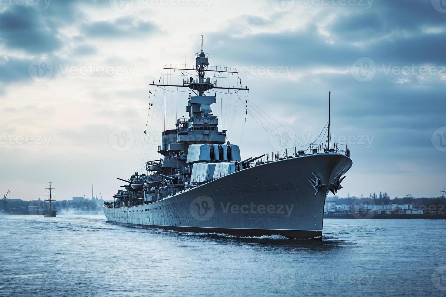 Battleship navigating through calm waters at dusk. photo