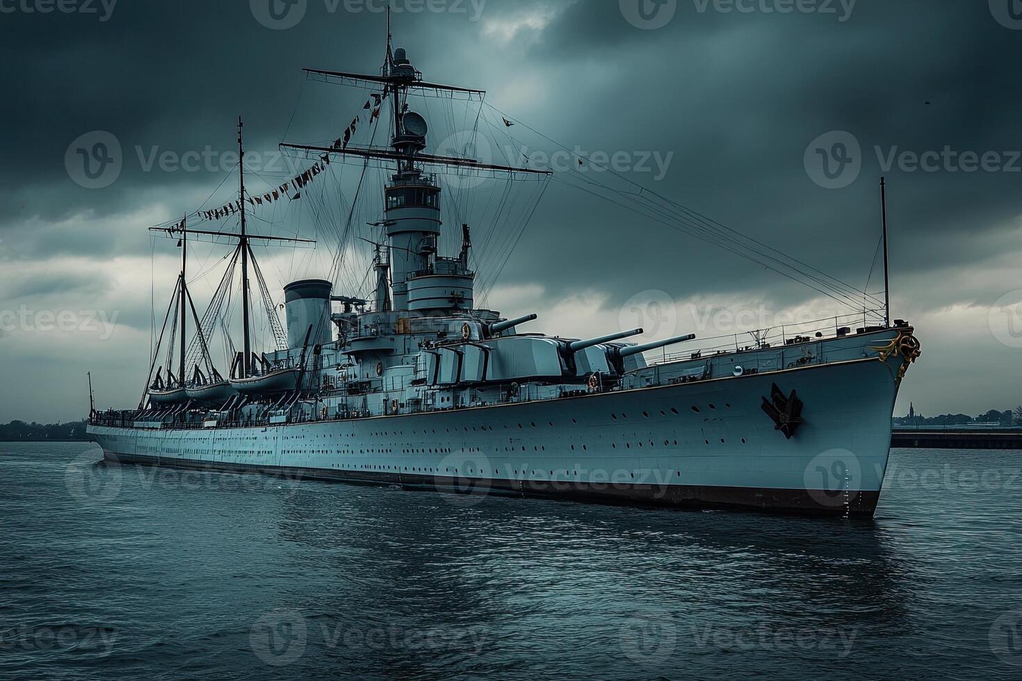 Historic battleship moored under a dramatic sky. photo