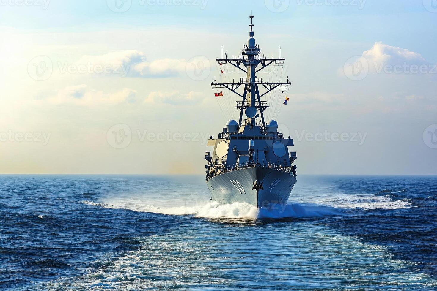 Naval destroyer navigating through ocean waters. photo