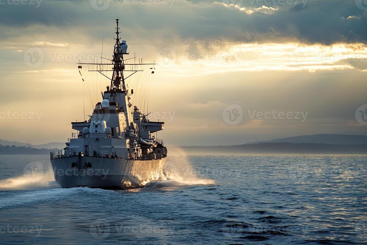 Naval ship navigating through calm waters at sunset. photo