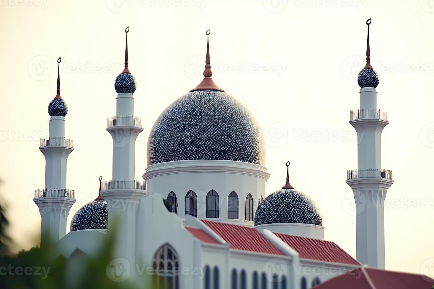 Majestic mosque with multiple domes and minarets against a clear sky. photo
