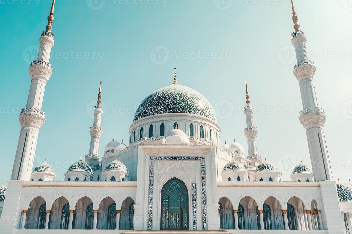 Majestic white mosque under a clear blue sky. photo