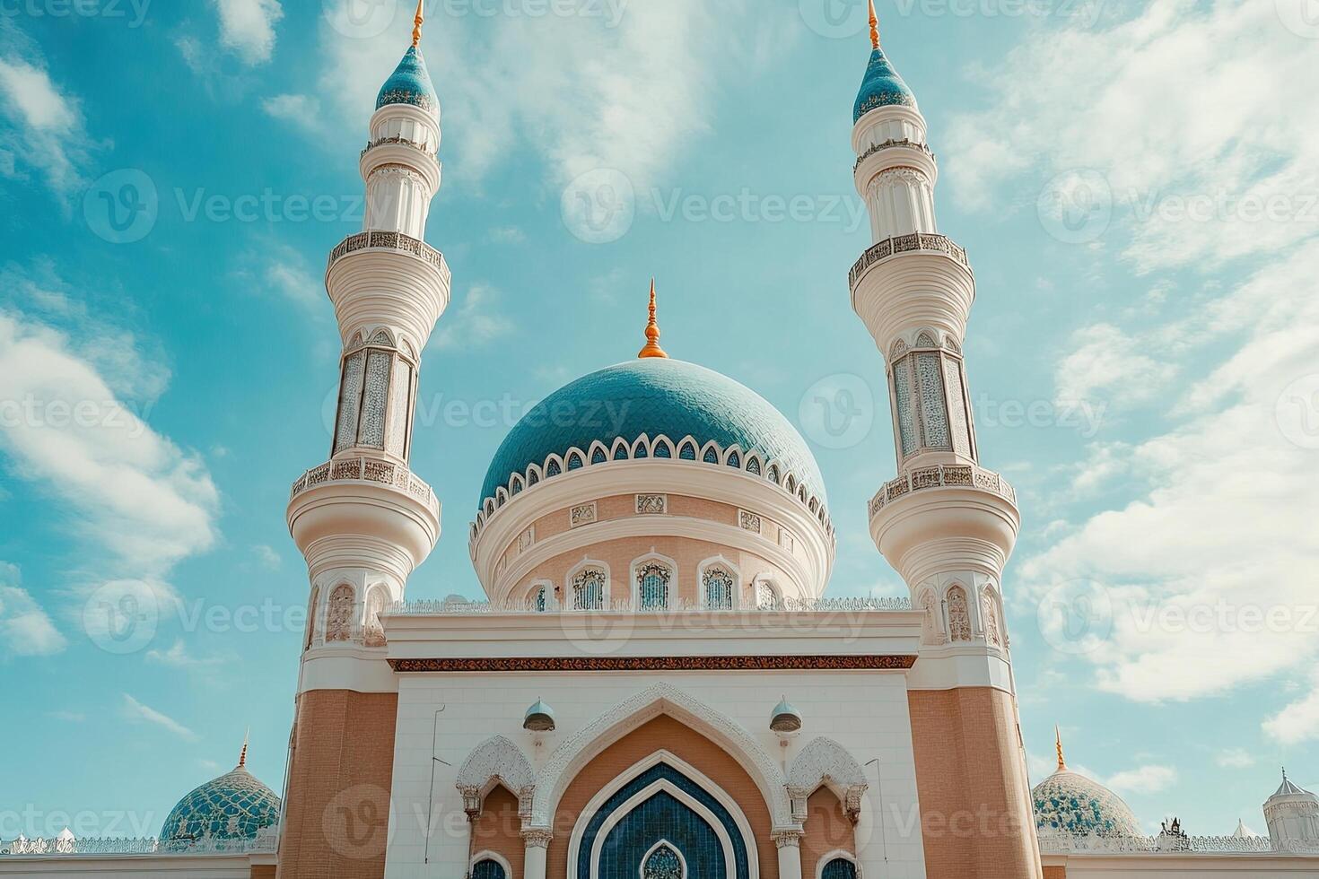 Low angle view of a beautiful blue domed mosque under a bright sky. photo