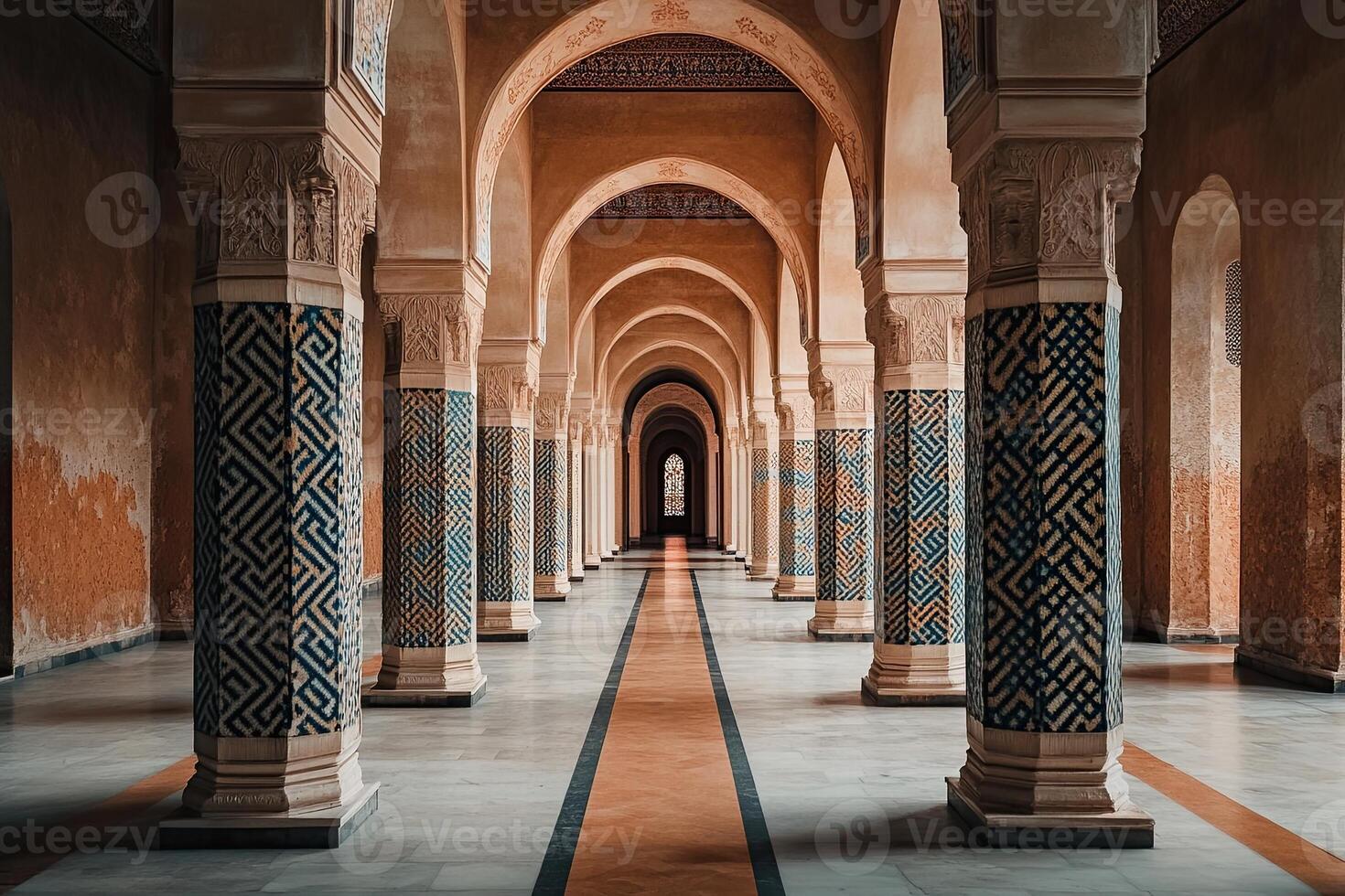 Long hallway with patterned columns and arches in a historic building. photo