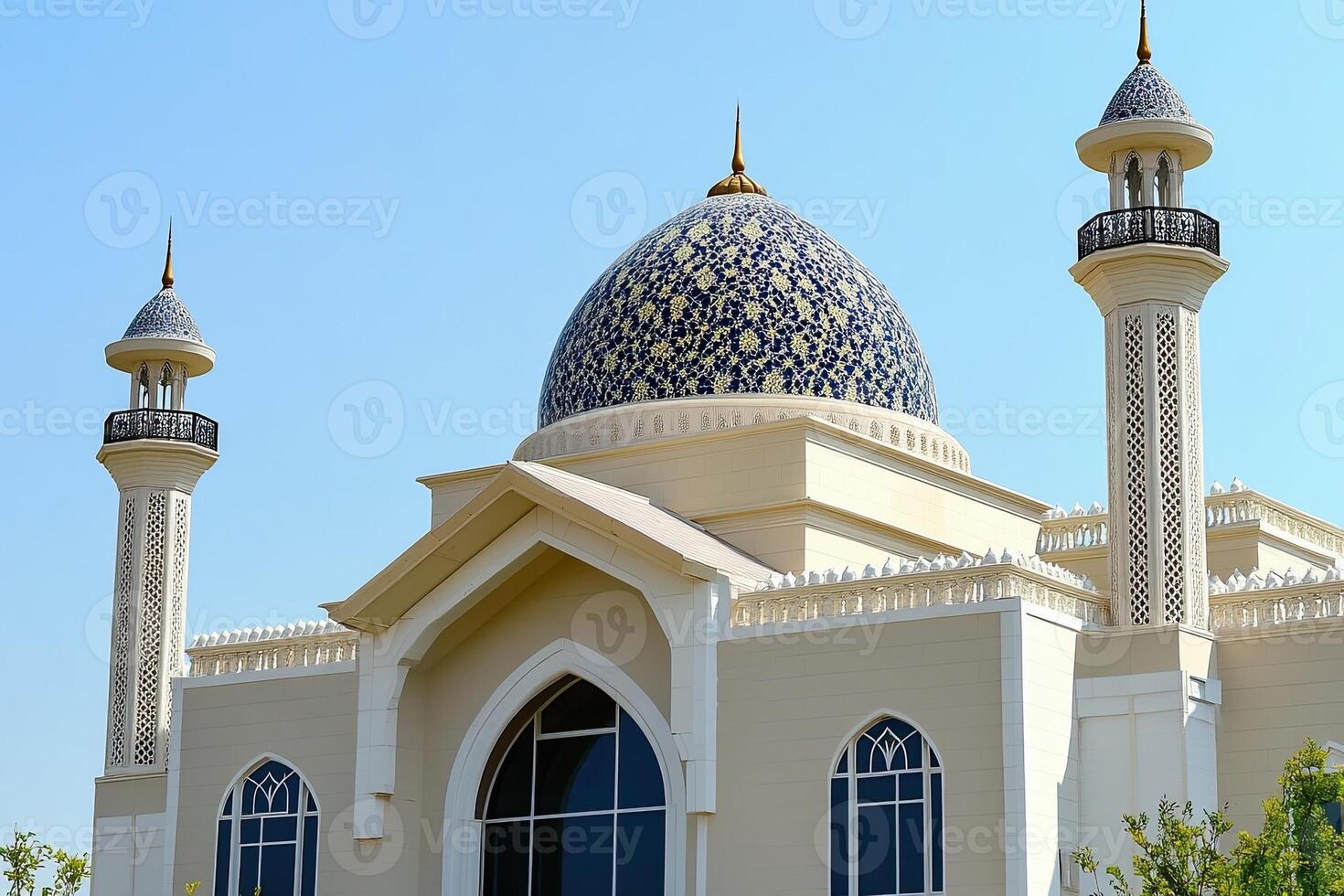 Ornate mosque dome and minarets under clear sky. photo