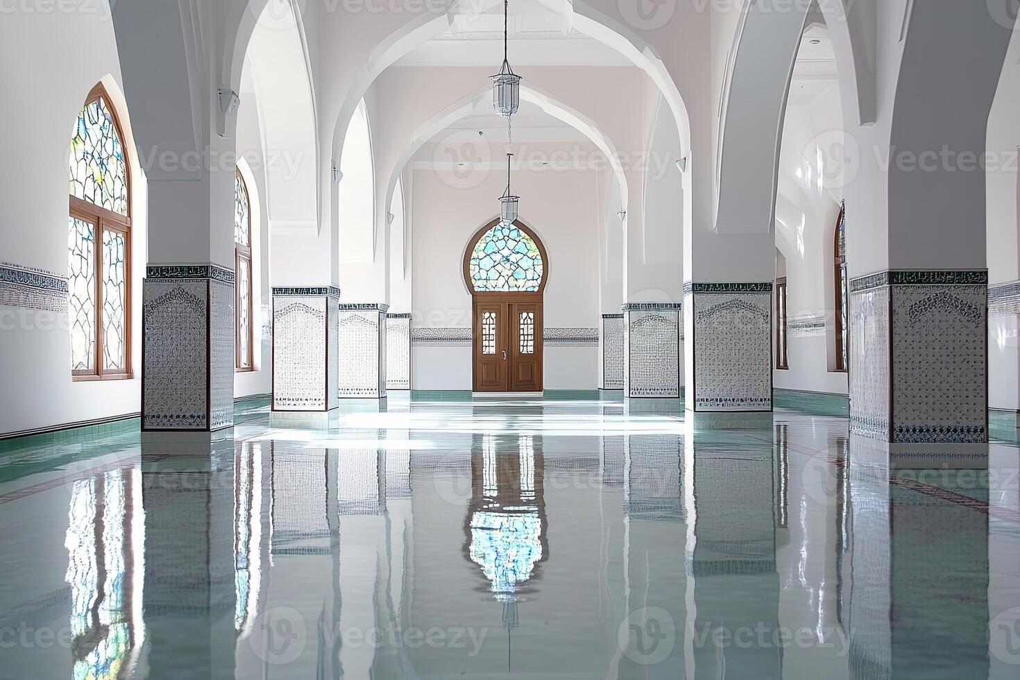 Reflective floor in a mosque's interior with arched entryway and stained-glass windows. photo