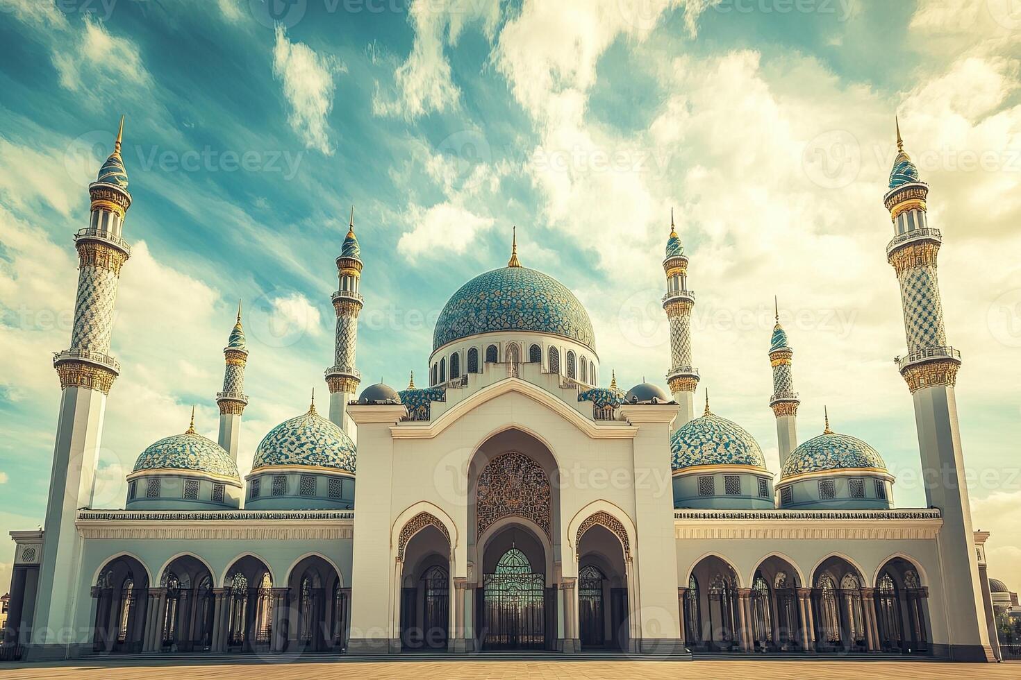 Majestic white mosque with blue domes under a vibrant sky. photo