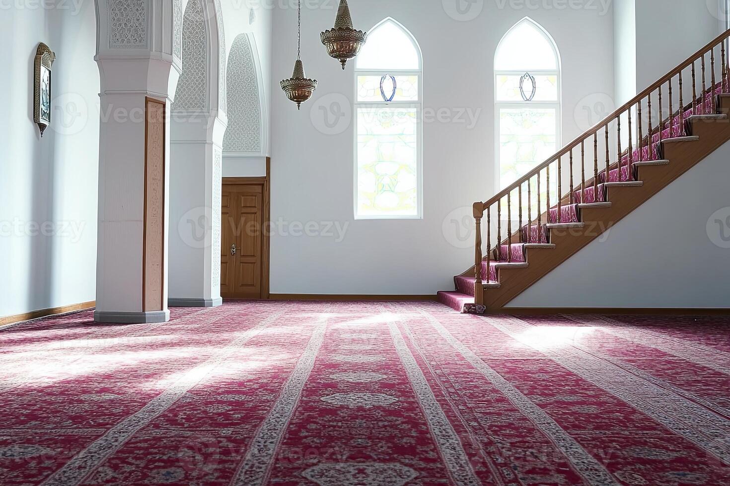 Serene mosque interior with sunlight streaming through stained-glass windows, illuminating a richly patterned prayer rug and wooden staircase. photo