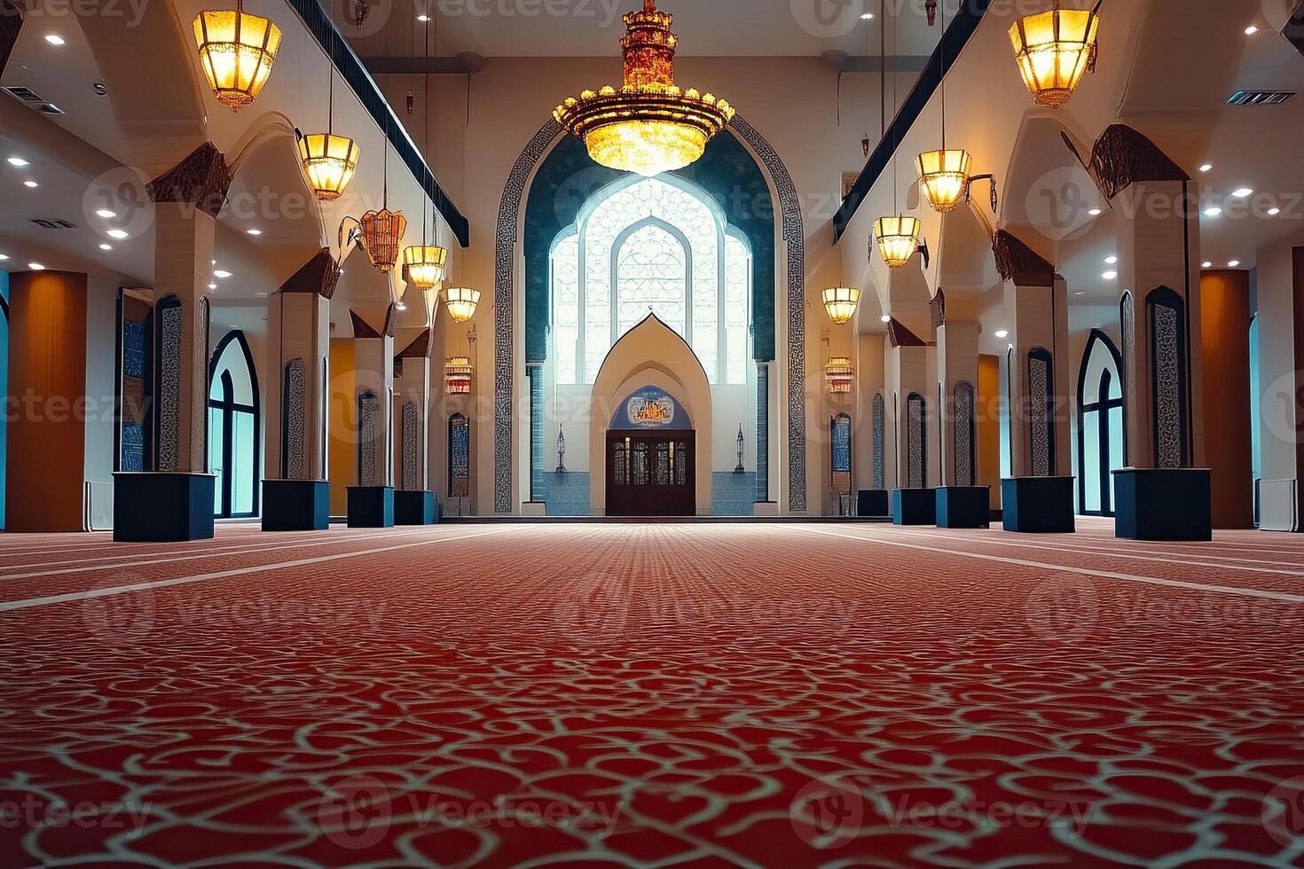 Spacious mosque interior with ornate carpet, arched windows, and chandeliers. photo