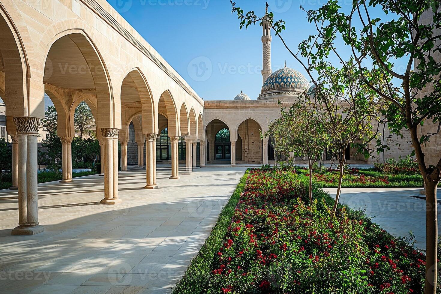 Sunlit courtyard with arched colonnade and mosque in background. photo