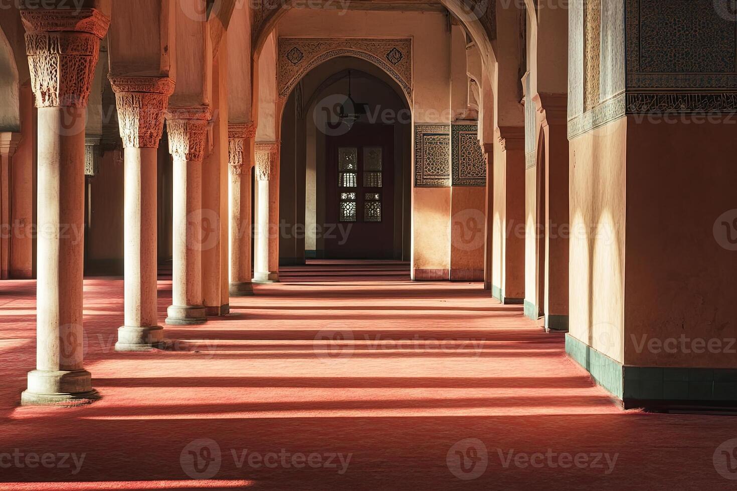 Sunlit corridor with arched columns and red carpet. photo