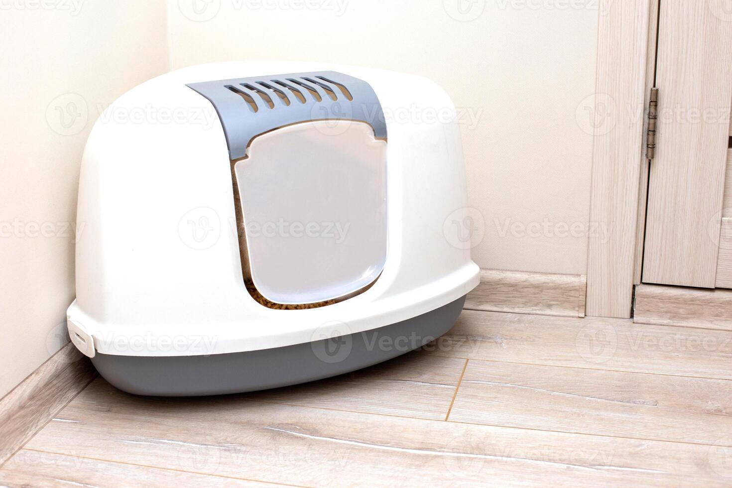 A large, gray, triangular plastic, enclosed litter box for a cat photo