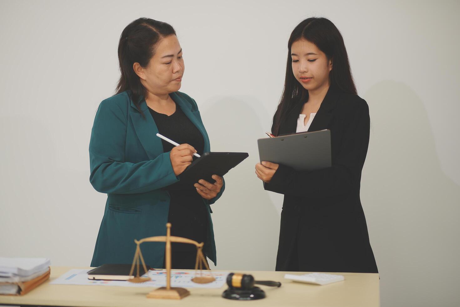 Pretty Asian female lawyer working and hammer, laptop, justice advice and legal concept. In office photo
