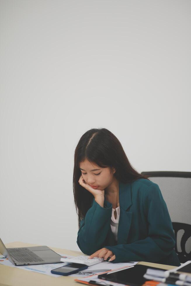 Stressed female worker and business woman holding a pile of paperwork while getting more work to do. Looking frustrated in camera, isolated on white background. Concept Too much work photo