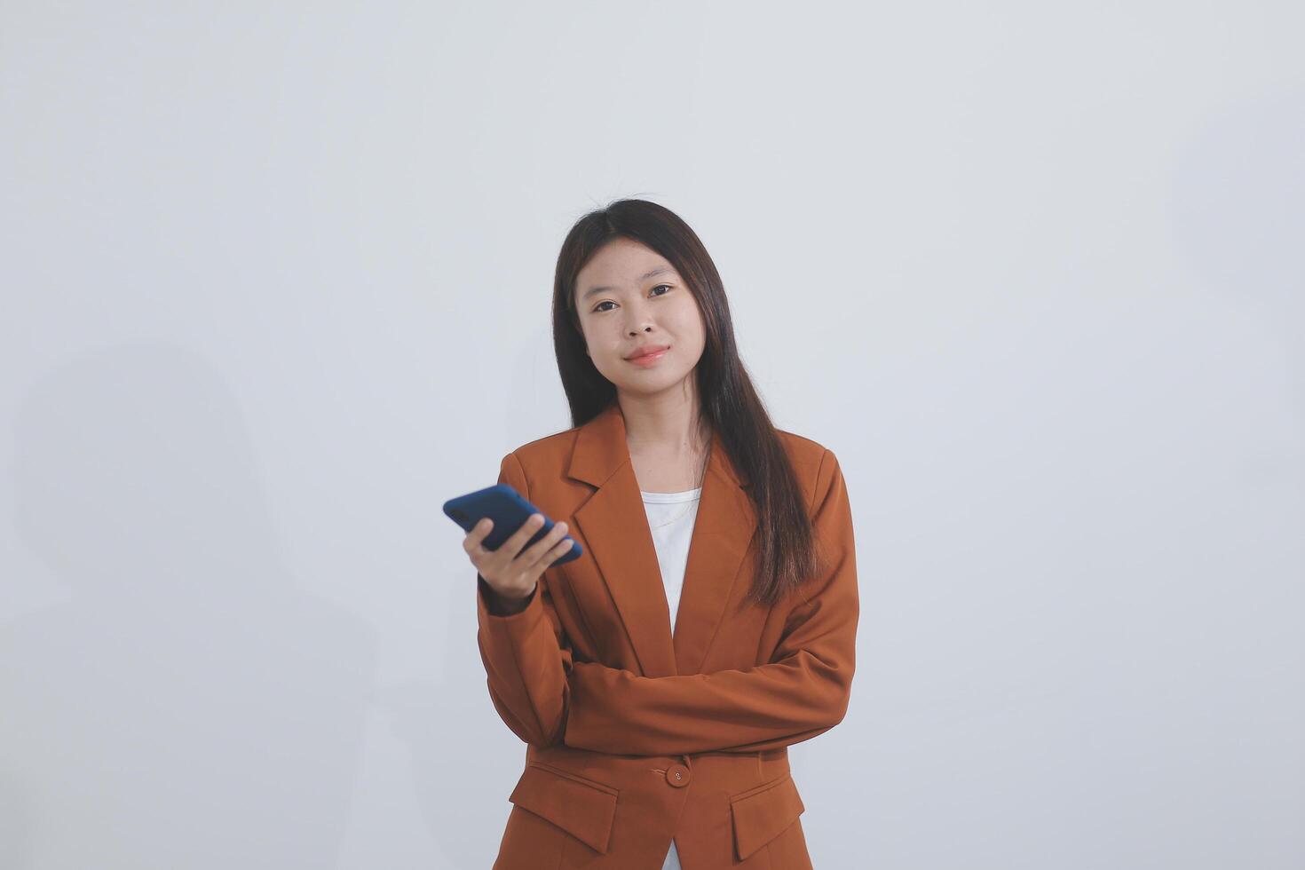 Young asian business woman in suit talking on smart phone isolated on white background, businesswoman speaking on smartphone with conversation, female holding cell phone, communication concept. photo