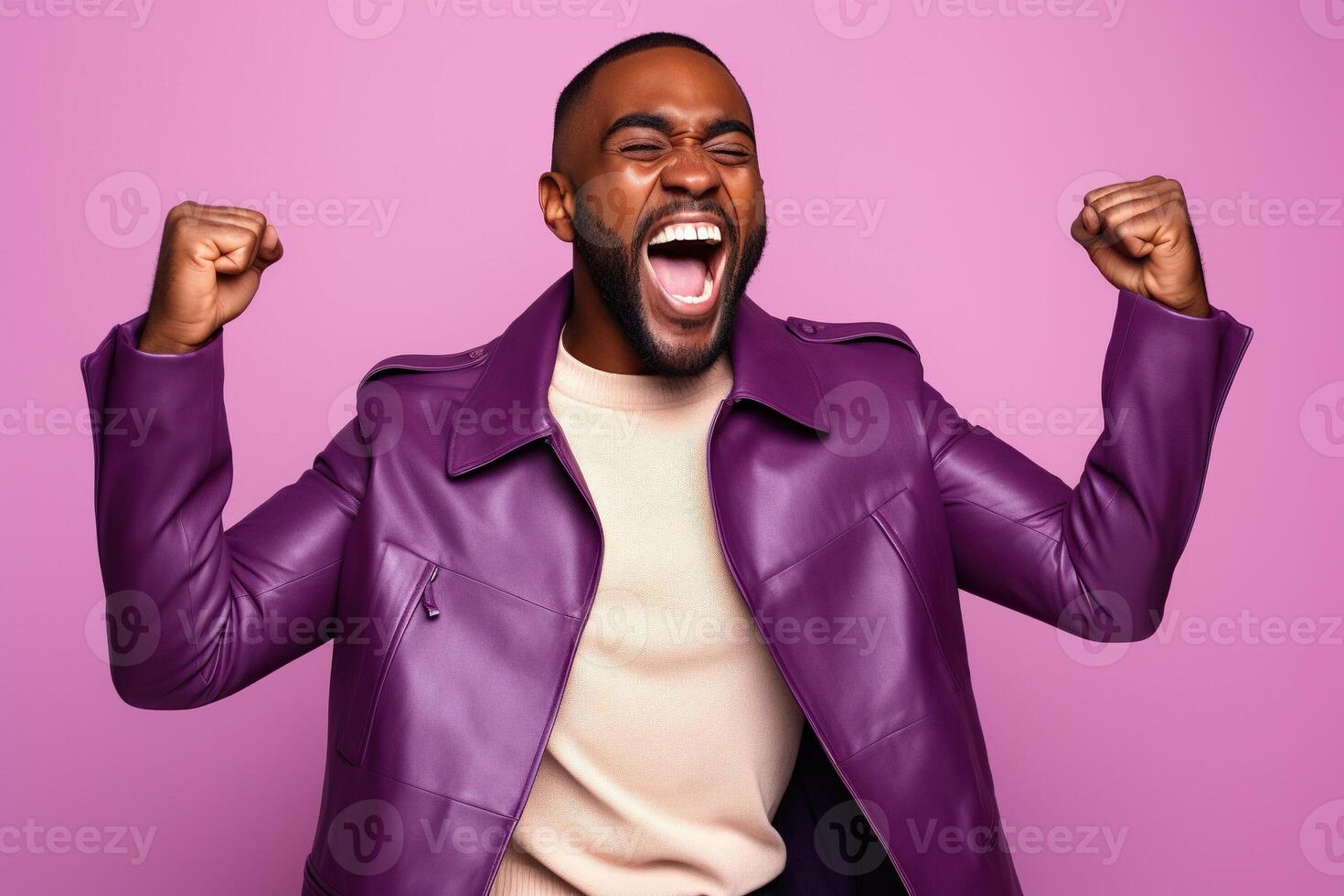 Overjoyed African American man dressed stylish clothes celebrate success raise hands fists isolated on purple color background photo