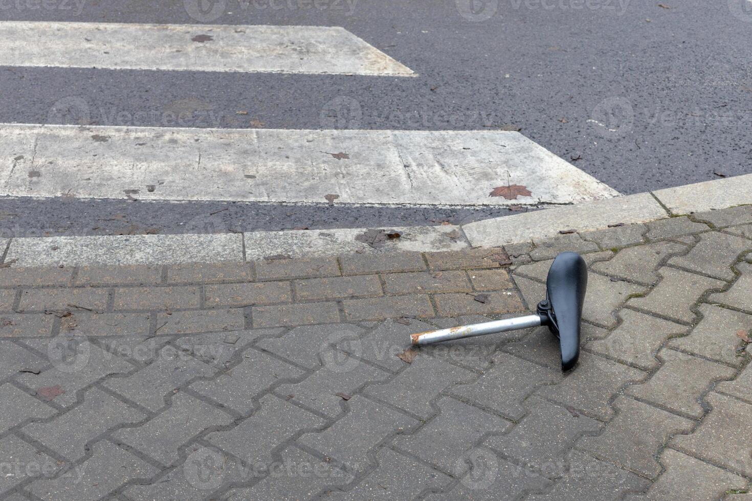 Abandoned Bicycle Seat on City Pavement photo