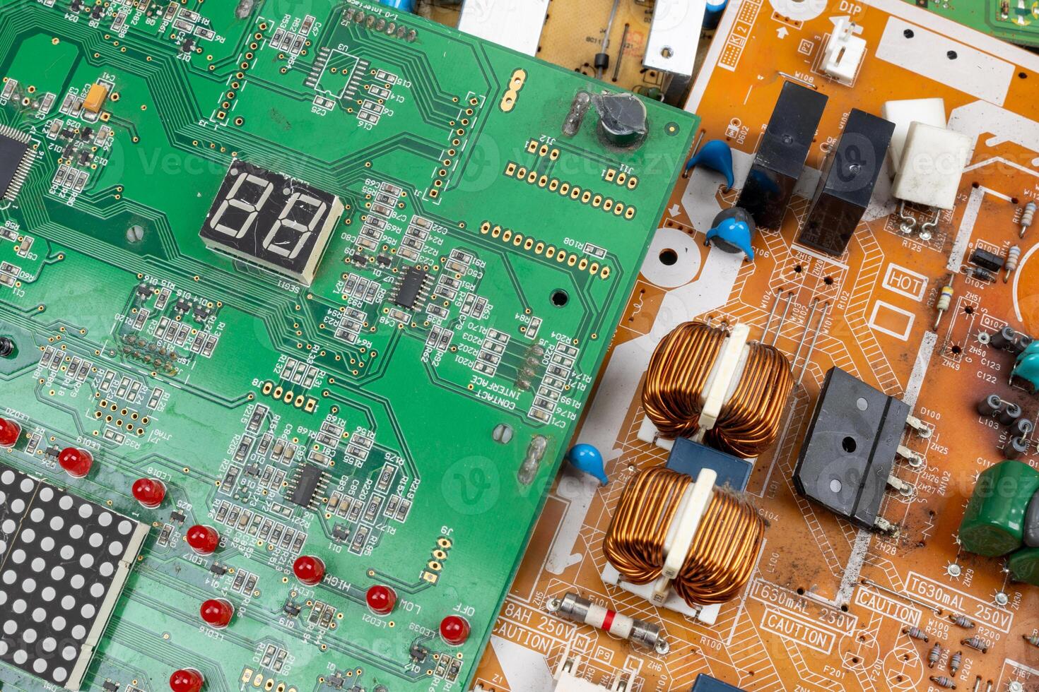 Close-Up of Green and Orange Circuit Boards with Electronic Components photo