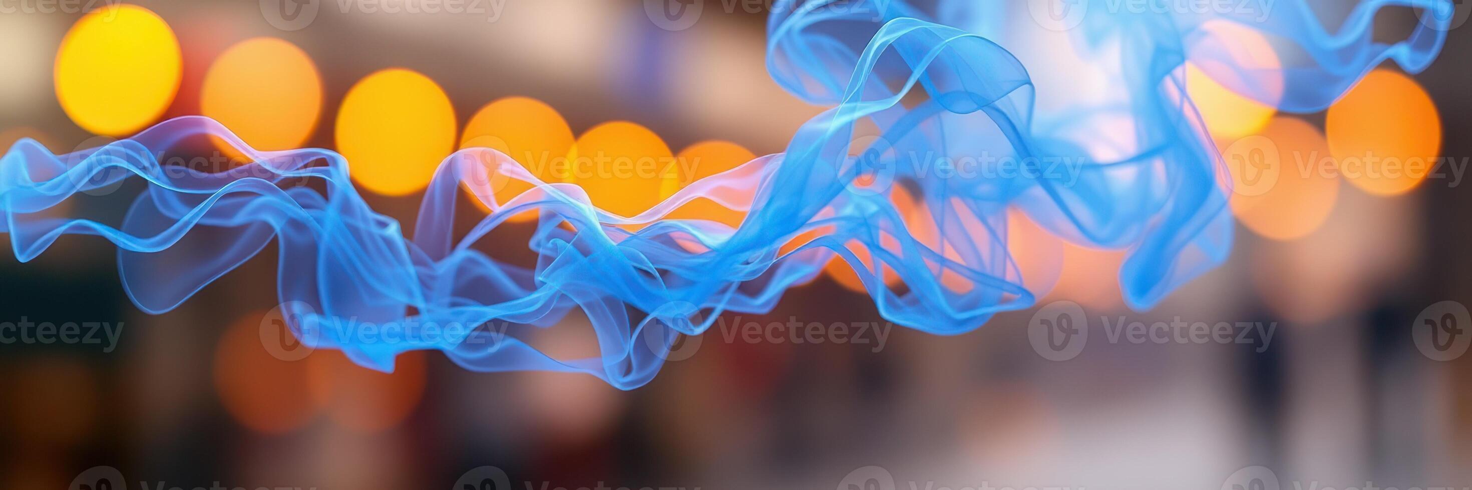 Colorful blue ribbons of fabric flowing through a softly lit space with warm golden bokeh lights in the background during evening hours photo
