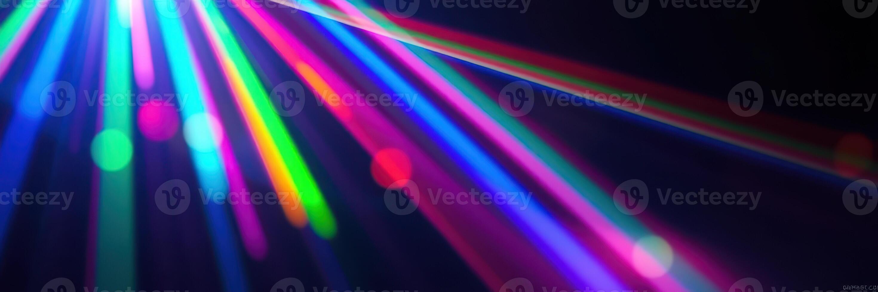 Colorful beams of light create a vibrant atmosphere in a dark space during a lively event photo