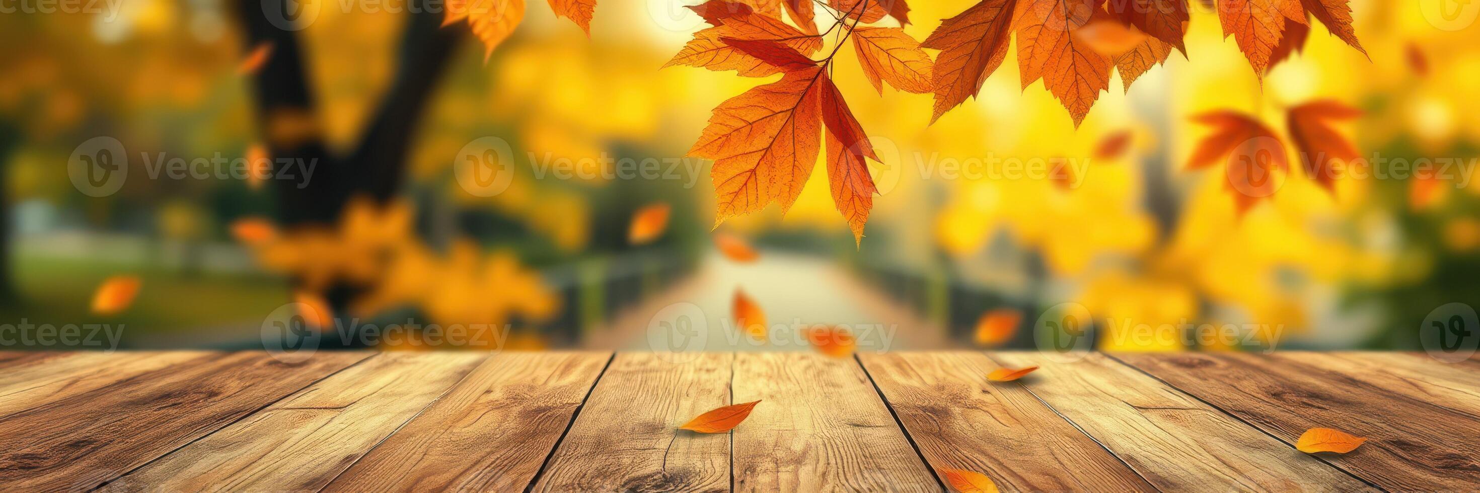 Vibrant autumn leaves fall onto a rustic wooden table in a serene park setting on a sunny day photo