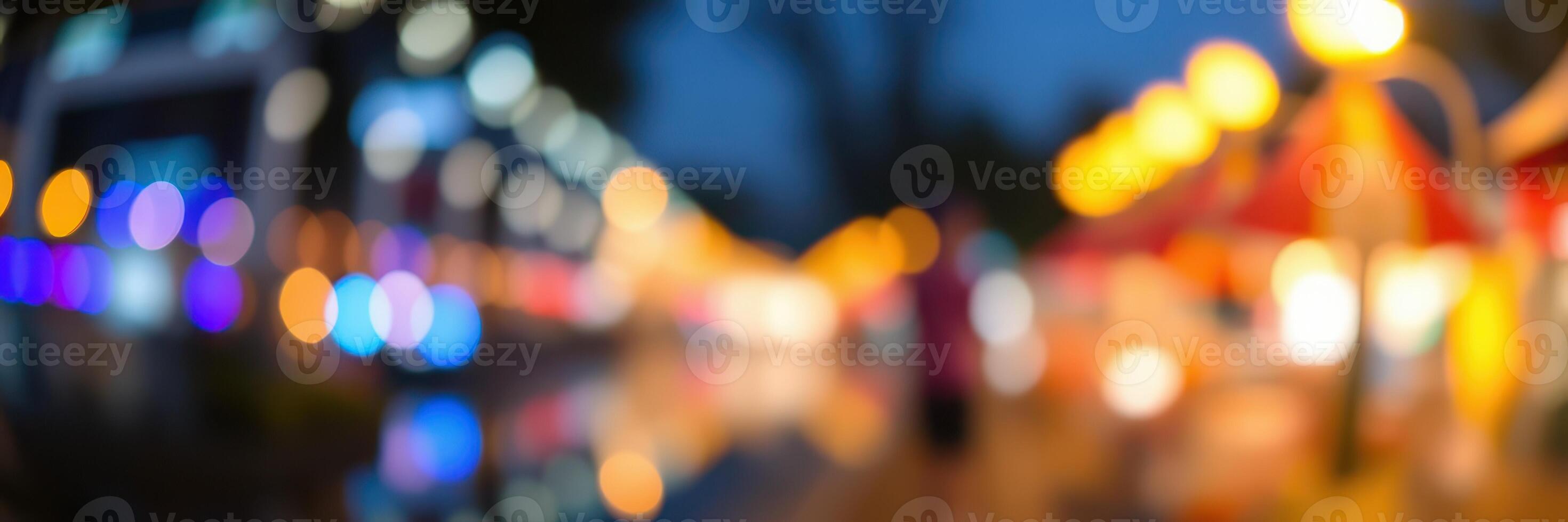 Colorful lights illuminate a bustling market during the evening hours, creating a vibrant atmosphere for visitors photo