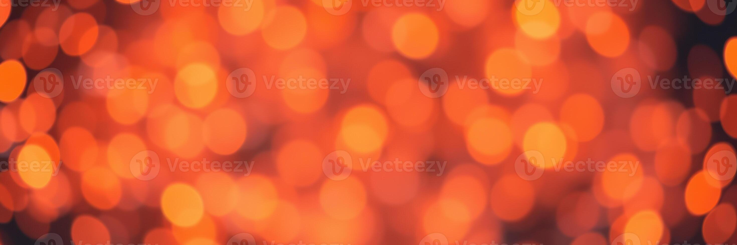 Warm glow of shimmering orange lights filling the background during a festive gathering in the evening photo