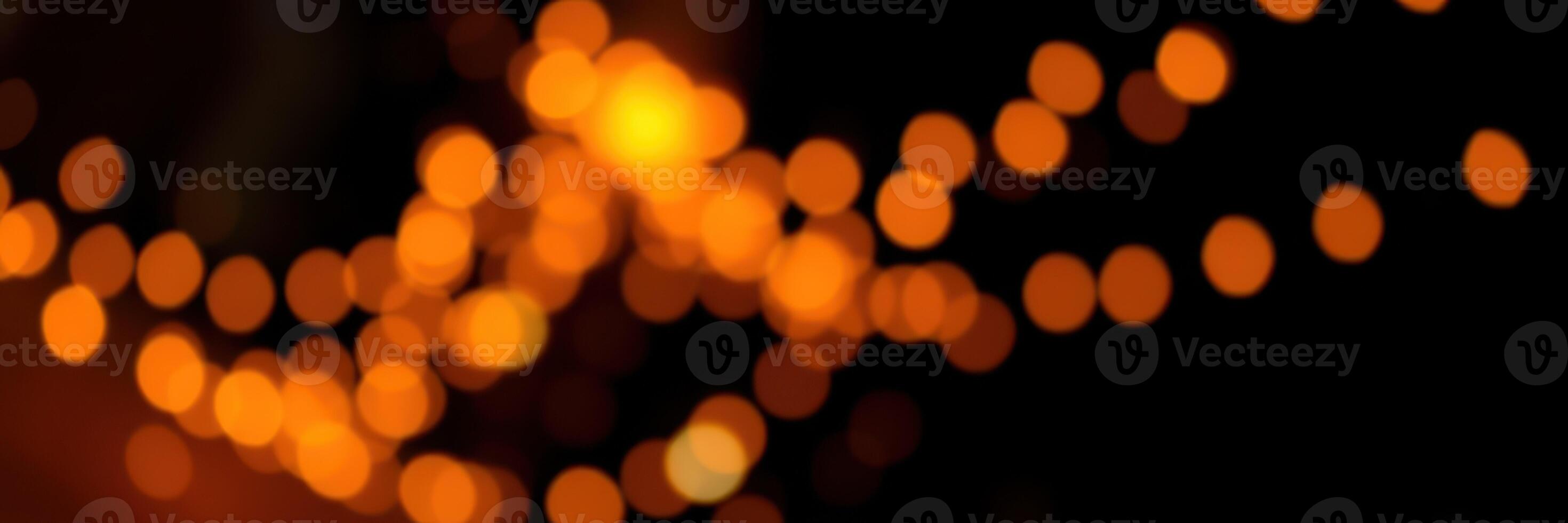 Warm glowing lights illuminate the night creating a festive atmosphere at an outdoor event photo
