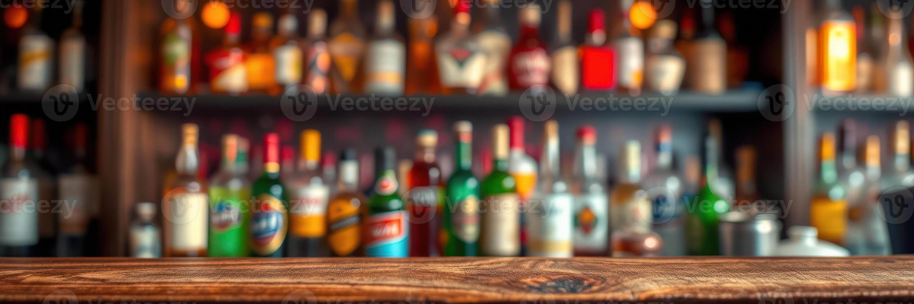 Bar counter with various colorful bottles neatly arranged on shelves in a cozy setting during evening hours photo