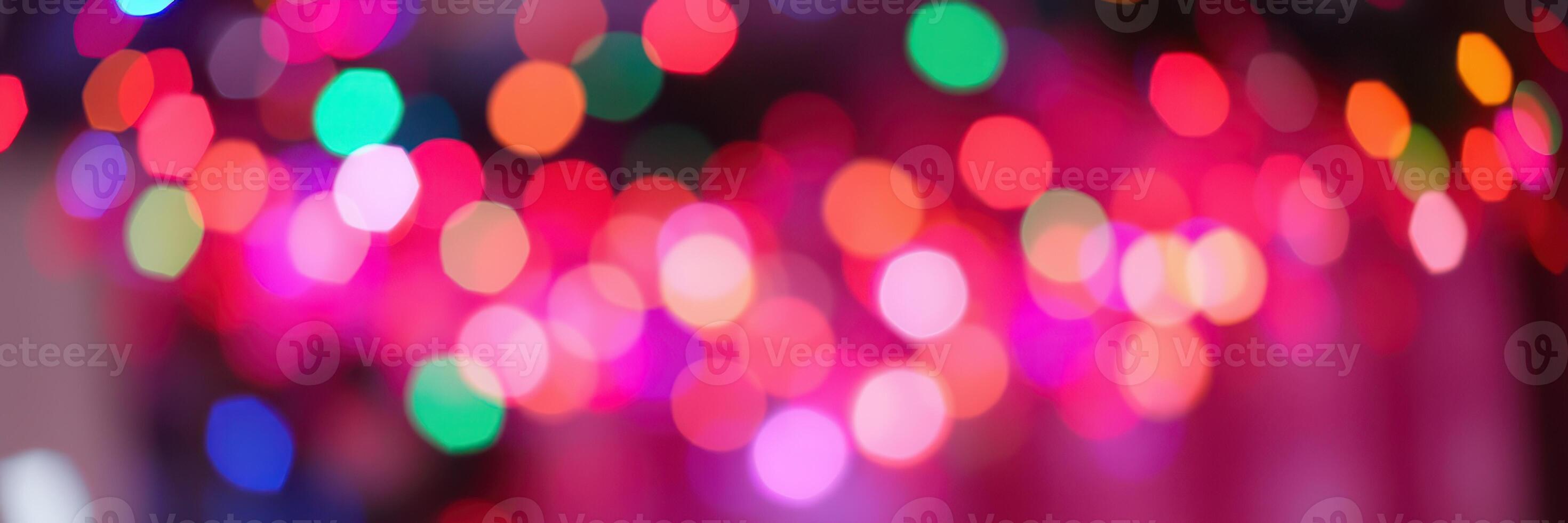Colorful bokeh lights create a festive atmosphere in a vibrant setting during a celebration at night photo
