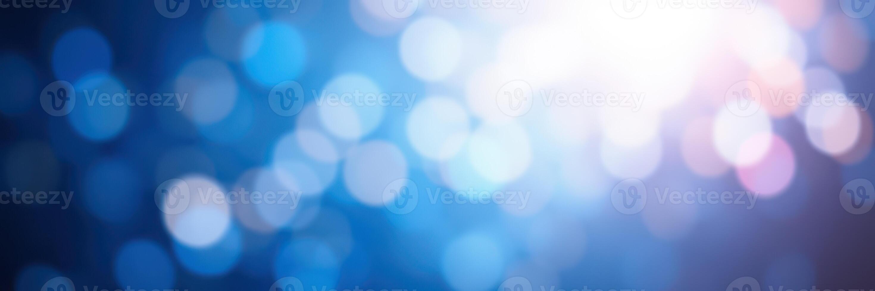 Soft blue and white bokeh lights create a dreamy atmosphere at a nighttime event or celebration photo