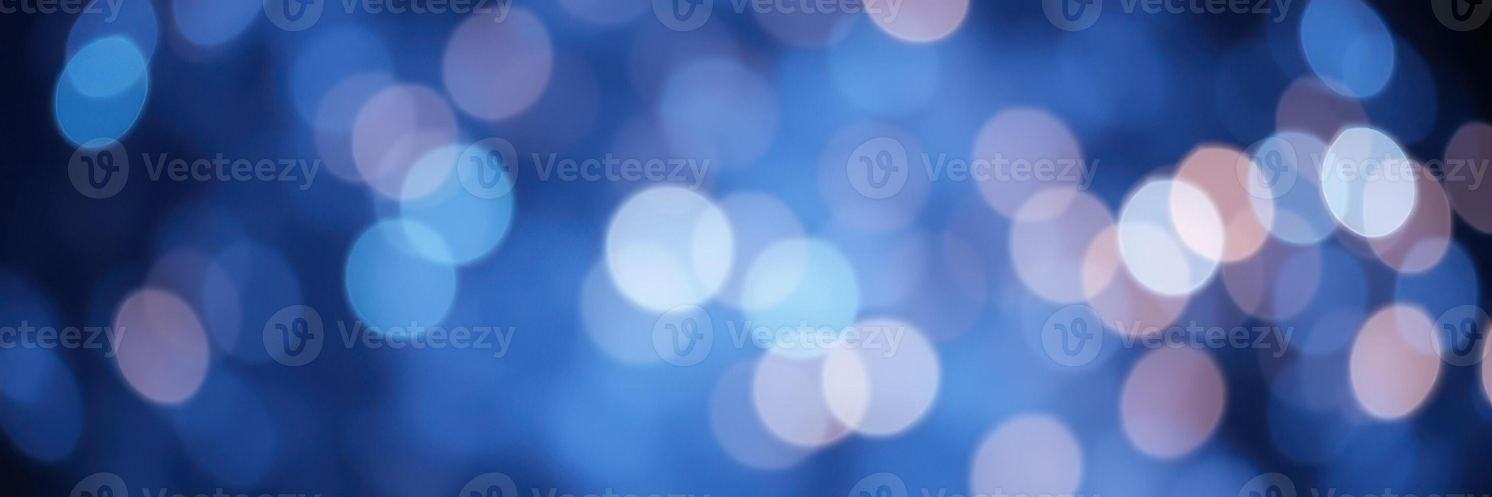Soft blue bokeh lights create a dreamy atmosphere in an abstract background during a nighttime event photo