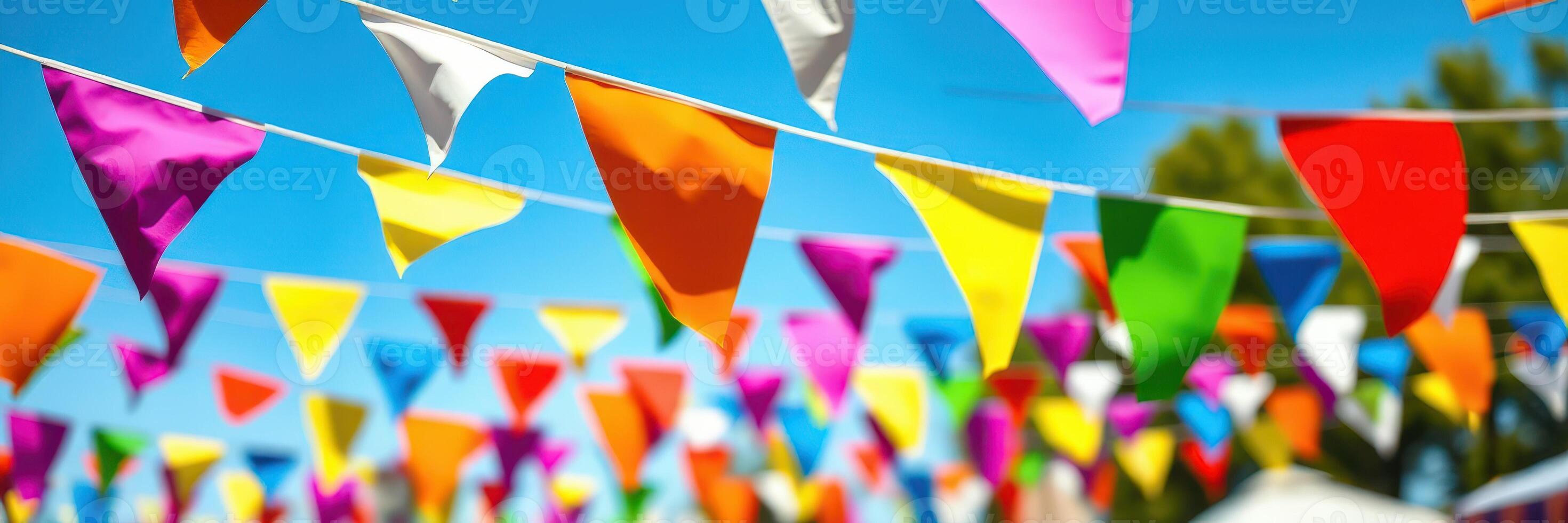 Colorful pennant banners decorate a vibrant outdoor festival during a sunny day in a lively neighborhood photo