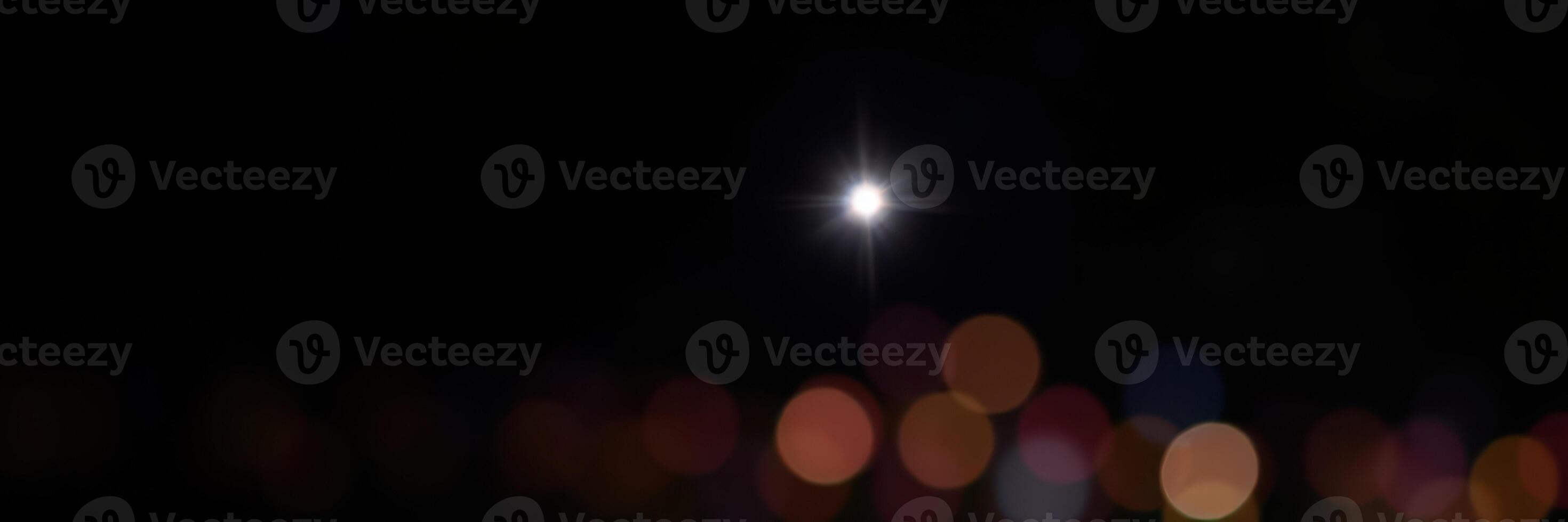 Illuminated night sky showcasing sparkling lights and a bright moon over a city landscape photo