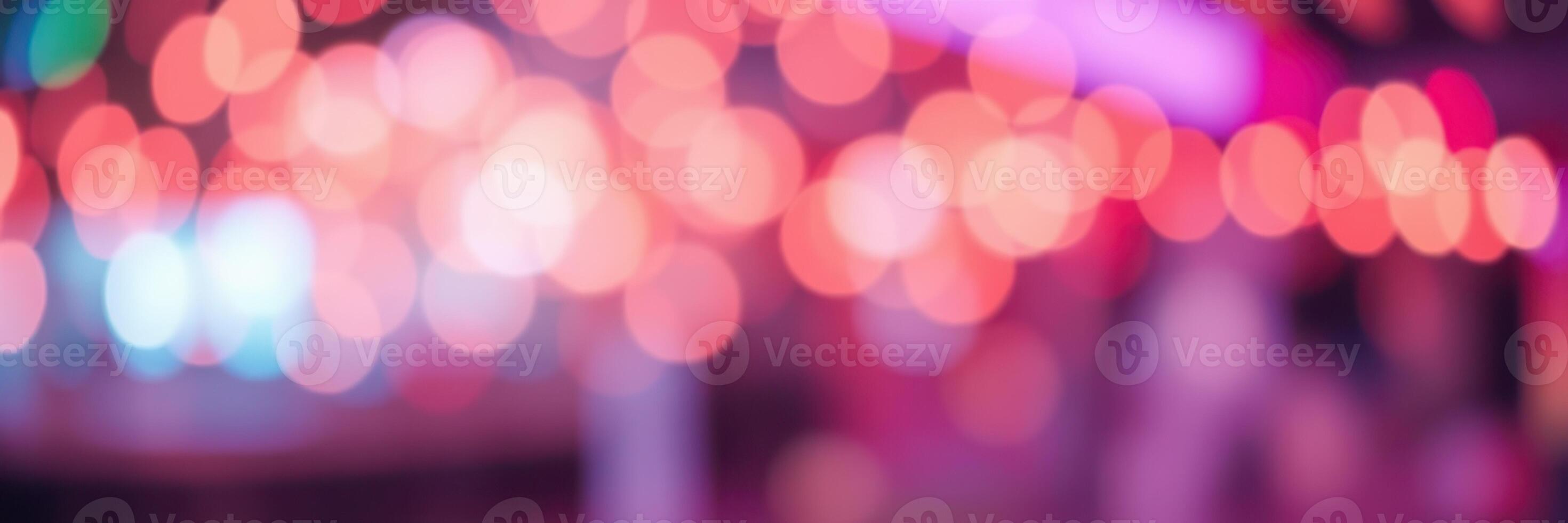 Colorful bokeh lights create an enchanting atmosphere at an outdoor event in the evening photo
