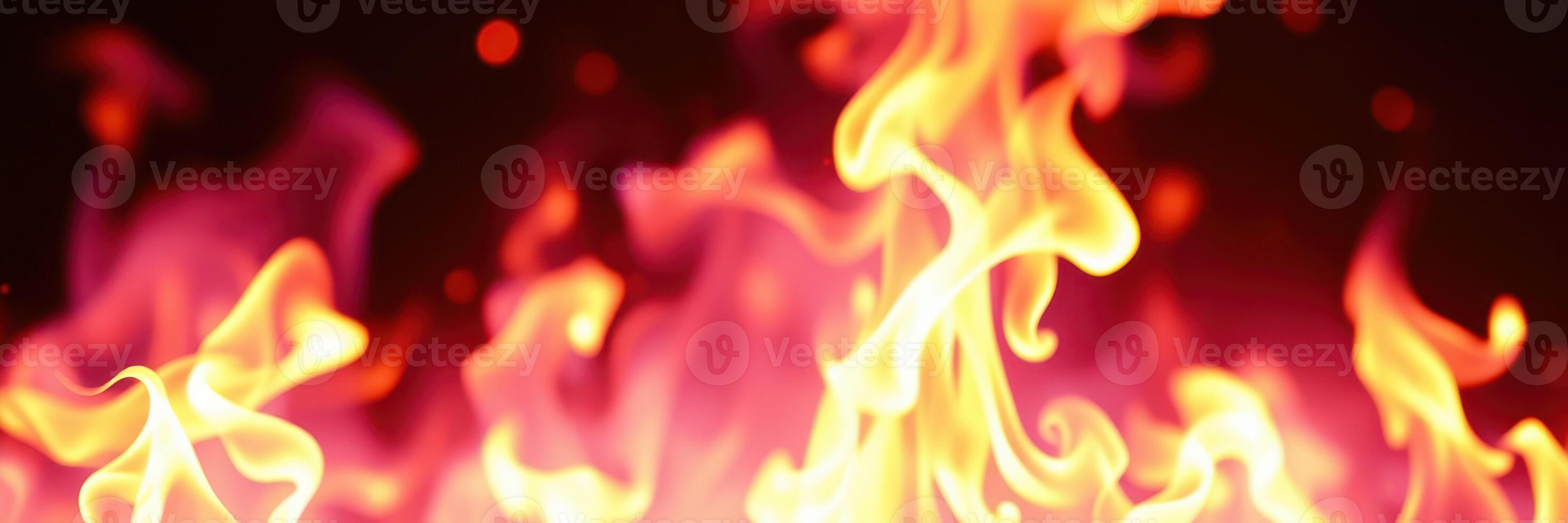 Fire flames dancing in vibrant colors creating a dramatic atmosphere in a dark setting photo