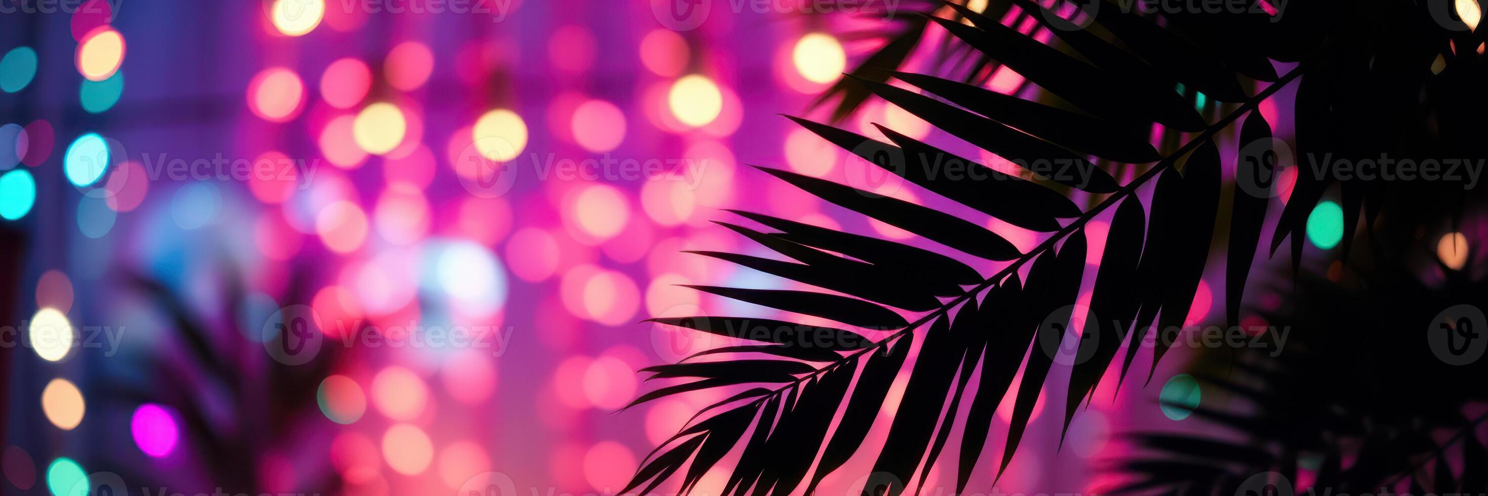 Festive lights twinkle against tropical leaves in a vibrant indoor setting during an evening gathering photo