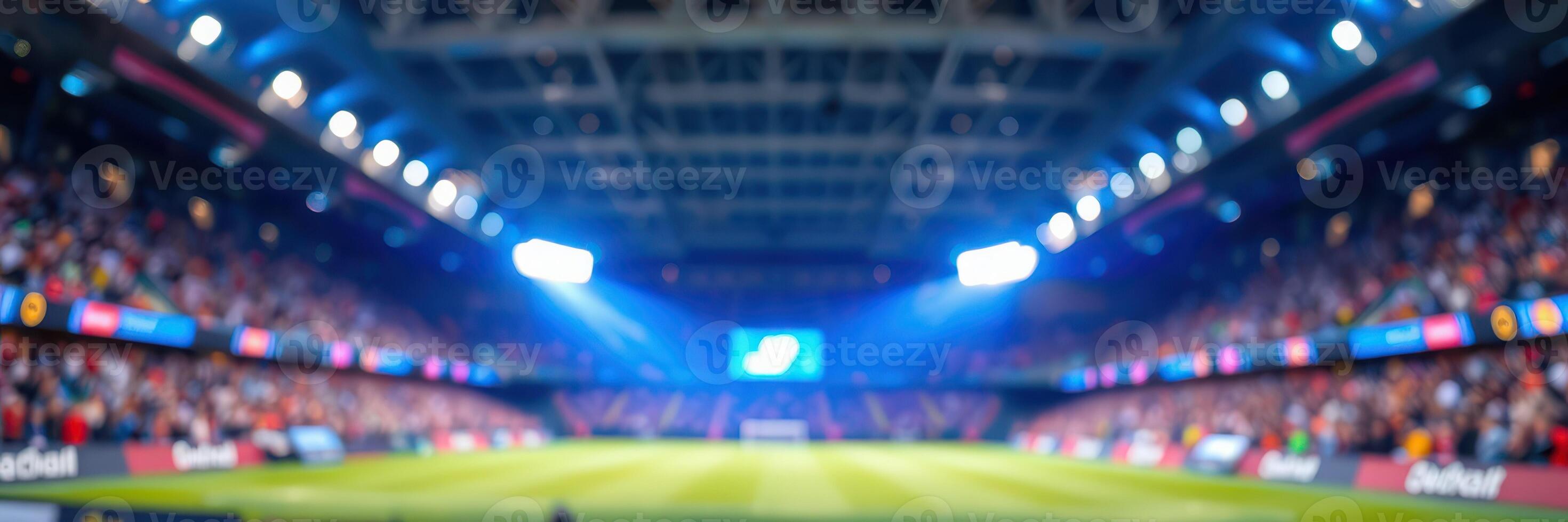 Exciting football match in a packed stadium under bright lights at night photo