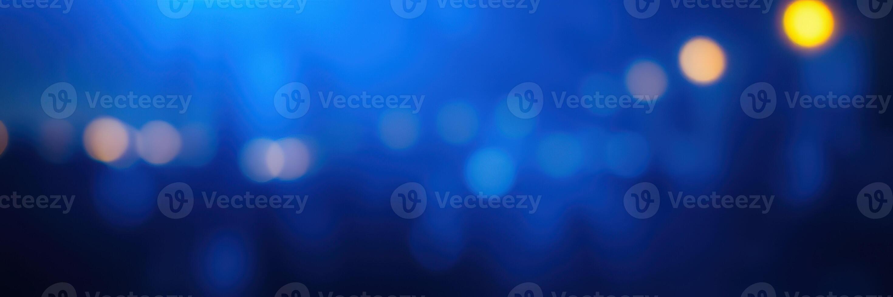 Vibrant bluish night scene with blurred lights creating a dreamy atmosphere during a festive event in an urban setting photo