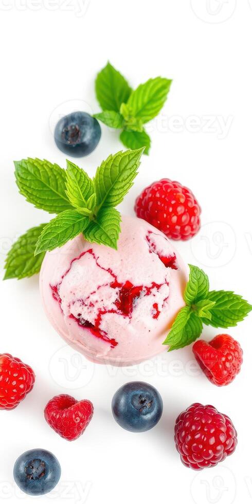 Fresh raspberry and blueberry ice cream topped with mint leaves on a white background photo