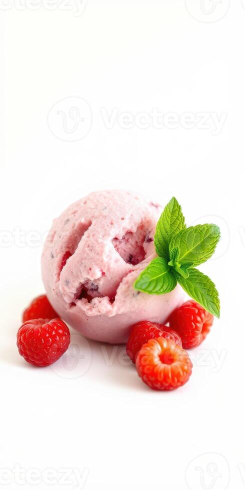 Sweet raspberry sorbet served with fresh raspberries and mint leaves on a clean white background photo