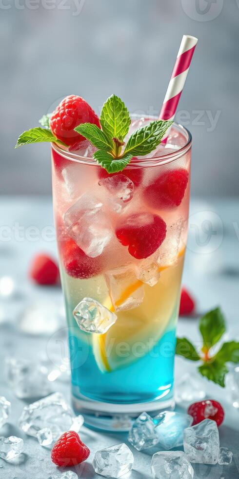 Refreshing layered beverage with ice and fruit in vibrant colors served in a tall glass photo