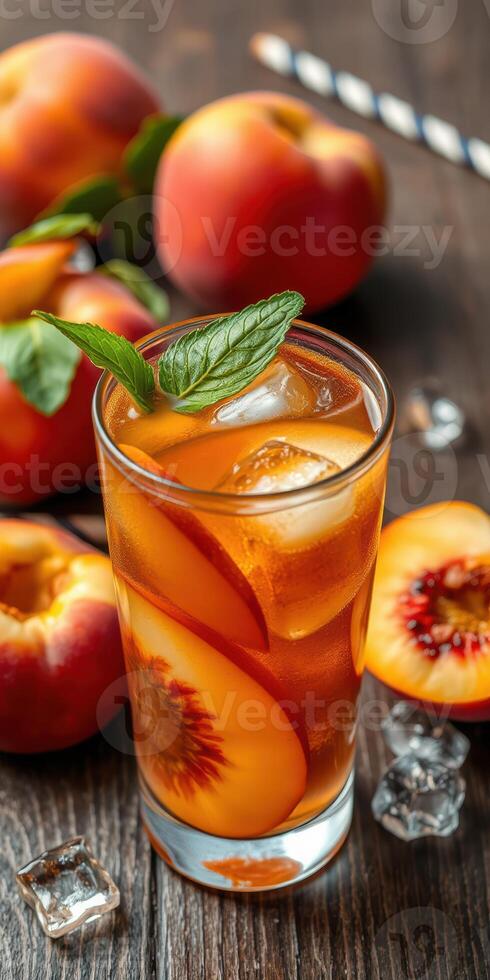 Refreshing peach iced tea garnished with mint and served with fresh peaches on a wooden table photo