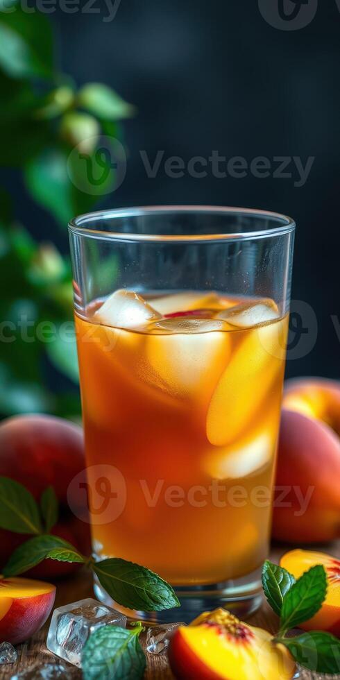 Refreshing iced tea with peaches and mint on a wooden table surrounded by fresh fruit photo