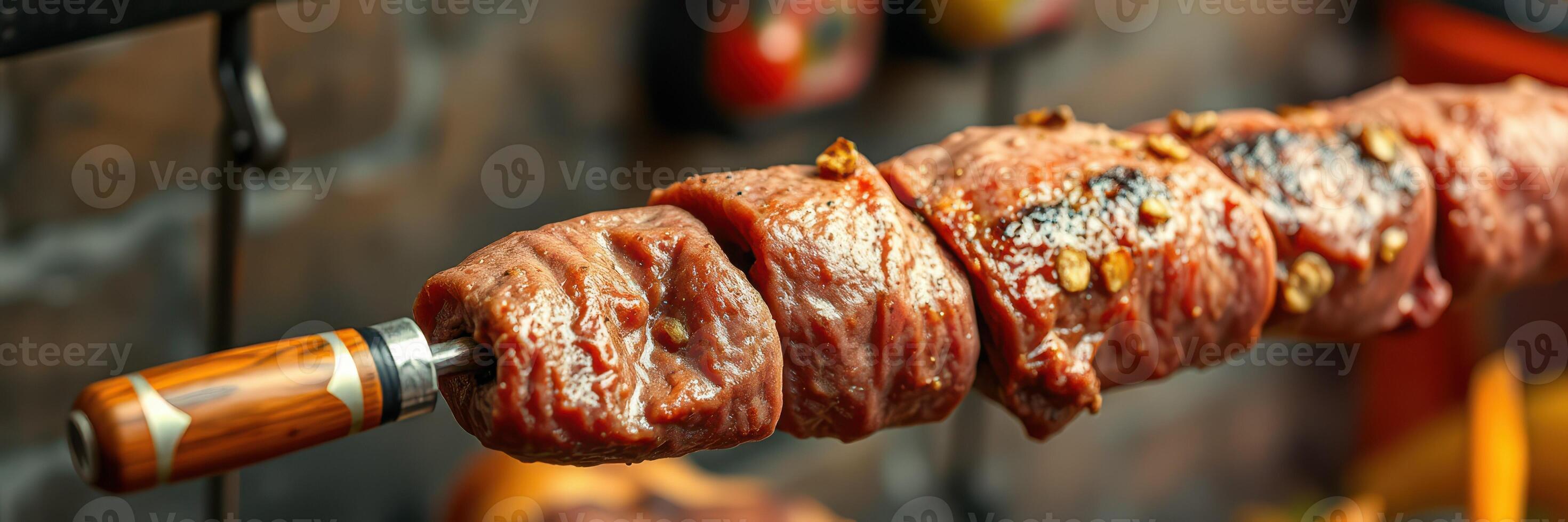 Juicy beef skewer being grilled over an open flame in a rustic outdoor kitchen setting photo