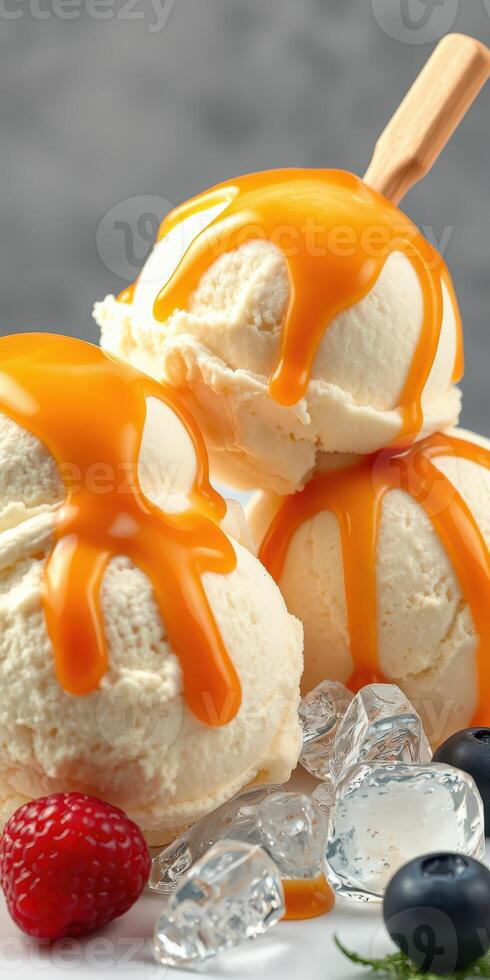 Delicious ice cream with caramel sauce and fresh berries served on a bed of ice photo